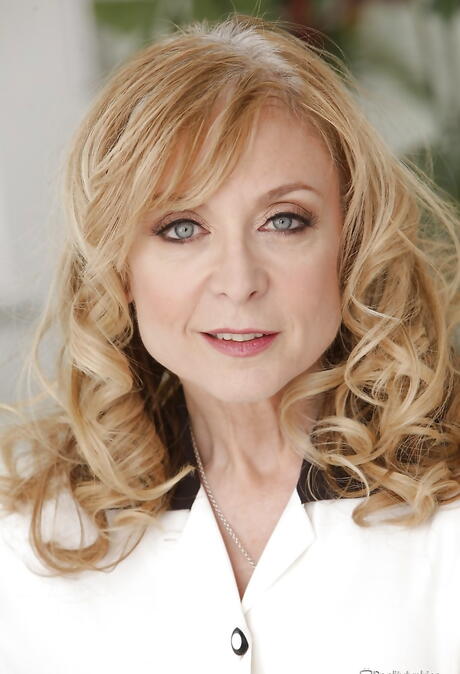 Excellent american blonde aged Nina Hartley revealing big tits and spreading her legs 